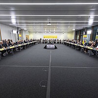 Impressionen vom Top-Level-Meeting beim Strategiedialog Automobilwirtschaft BW, alle Teilnehmenden sitzen in einem Konferenzraum