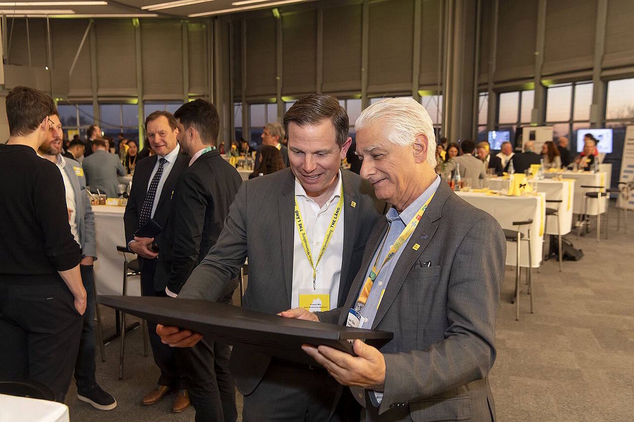 Gunnar Mey und Luiz Cesio Alves stehen im Gespräch nebeneinander