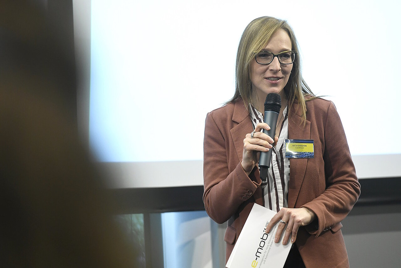 Katja Gicklhorn, e-mobil BW, hält ein Mikrofon in der Hand und hält einen Vortrag.