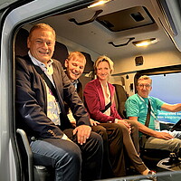 Dr. Nicole Hoffmeister-Kraut (z.v.r.) und e-mobil BW Geschäftsführer Franz Loogen (links) bei der Probefahrt im eActros 300 von Daimler Trucks. 