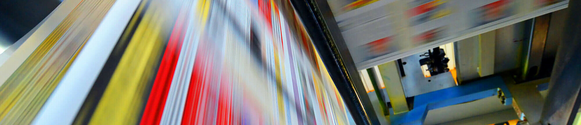 Druckpapier einer Zeitung läuft über eine Walze.