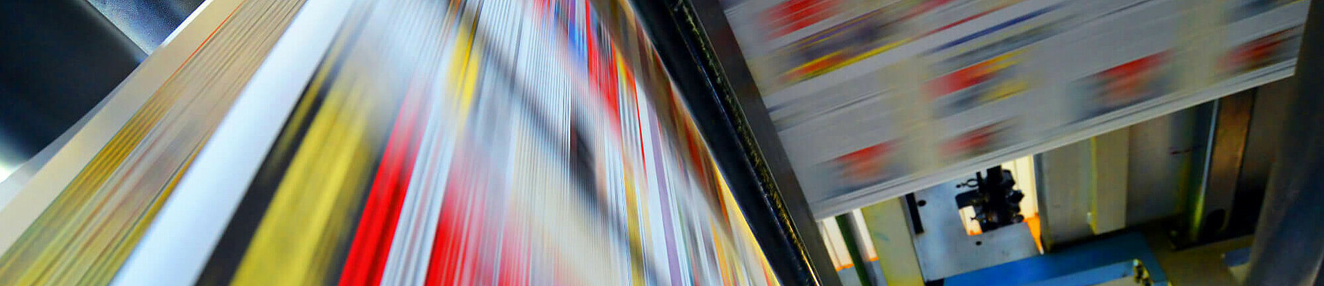 Druckpapier einer Zeitung läuft über eine Walze.