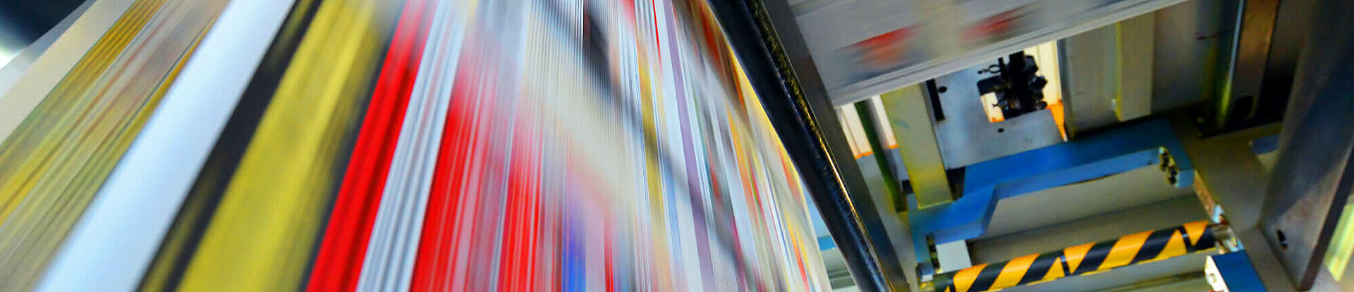 Druckpapier einer Zeitung läuft über eine Walze.